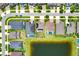 Stunning aerial view of homes with pools surrounding a picturesque pond in a well-maintained neighborhood at 11612 Sunburst Marble Rd, Riverview, FL 33579