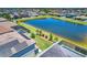 Aerial view highlighting a community with pond views, homes with solar panels, and manicured lawns at 11612 Sunburst Marble Rd, Riverview, FL 33579