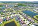 Overhead view of a community featuring houses with pools, surrounded by ponds and landscaped streets at 11612 Sunburst Marble Rd, Riverview, FL 33579