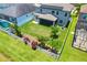 Aerial view of a home highlighting its spacious backyard, white fence, mature landscaping, and screened in patio at 11612 Sunburst Marble Rd, Riverview, FL 33579