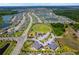 An aerial view showcasing a Primary-planned community with houses, community park, and scenic ponds at 11612 Sunburst Marble Rd, Riverview, FL 33579