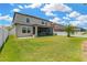 Expansive backyard with a screened-in porch, pristine lawn, and white fencing, perfect for outdoor enjoyment at 11612 Sunburst Marble Rd, Riverview, FL 33579