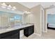 Well-lit bathroom boasts double vanity, granite countertops, and a large mirror, perfect for a modern lifestyle at 11612 Sunburst Marble Rd, Riverview, FL 33579