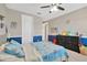 Well-appointed bedroom with blue and grey walls, carpeted floors, a ceiling fan, and a cozy atmosphere at 11612 Sunburst Marble Rd, Riverview, FL 33579