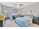 Cheerful bedroom with a blue accent wall, carpeted floors, a ceiling fan, and a window offering ample natural light at 11612 Sunburst Marble Rd, Riverview, FL 33579