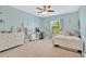 Bright bedroom with blue walls, carpeted floors, a ceiling fan, and natural light from the window at 11612 Sunburst Marble Rd, Riverview, FL 33579