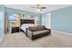 Inviting bedroom with light blue walls, carpeted floors, ceiling fan, and two windows providing plenty of natural light at 11612 Sunburst Marble Rd, Riverview, FL 33579