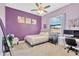Cozy bedroom with purple walls, natural light, and simple decor with a computer desk at 11612 Sunburst Marble Rd, Riverview, FL 33579