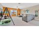 Spacious bonus room with comfortable seating, natural light, and flexible living space at 11612 Sunburst Marble Rd, Riverview, FL 33579