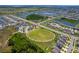 Aerial view of a large park with a playground and vast open space, ideal for outdoor activities at 11612 Sunburst Marble Rd, Riverview, FL 33579