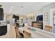 Open floor plan with dining area, modern light fixture, and kitchen with island in the background at 11612 Sunburst Marble Rd, Riverview, FL 33579