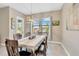 Dining room with table, chairs, modern lighting, and sliding door to the backyard at 11612 Sunburst Marble Rd, Riverview, FL 33579