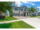 Beautiful two-story home with a well-maintained lawn, brick driveway, and a two-car garage at 11612 Sunburst Marble Rd, Riverview, FL 33579