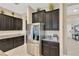 Modern kitchen featuring dark cabinets, stainless steel appliances, and granite countertops at 11612 Sunburst Marble Rd, Riverview, FL 33579