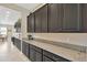 Elegant kitchen with dark cabinetry, granite countertops, and modern appliances at 11612 Sunburst Marble Rd, Riverview, FL 33579