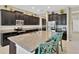 Spacious kitchen with stainless steel appliances, dark cabinets, granite counters, and island with seating at 11612 Sunburst Marble Rd, Riverview, FL 33579