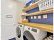 Organized laundry room with floating shelves, modern appliances, and stylish decor enhancing functionality at 11612 Sunburst Marble Rd, Riverview, FL 33579