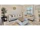 Bright living room with modern decor, plush sofas, a decorative rug, and ample natural light at 11612 Sunburst Marble Rd, Riverview, FL 33579