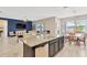 Open concept living room and kitchen with granite island, eat-in-kitchen and decorative blue wall at 11612 Sunburst Marble Rd, Riverview, FL 33579
