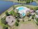 Aerial view of a community pool area with a playground, lounge chairs, and palm trees at 11623 Tetrafin Dr, Riverview, FL 33579