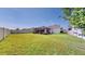 Spacious backyard with lush green grass and covered patio, perfect for outdoor enjoyment at 11623 Tetrafin Dr, Riverview, FL 33579