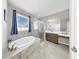 Bright bathroom featuring vanity, soaking tub, and glass shower at 11623 Tetrafin Dr, Riverview, FL 33579