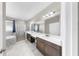 Bathroom featuring double sinks, walk-in shower, soaking tub, and modern fixtures at 11623 Tetrafin Dr, Riverview, FL 33579
