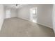 Spacious bedroom with neutral carpet, ceiling fan, and en suite bathroom entrance at 11623 Tetrafin Dr, Riverview, FL 33579