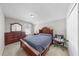 Comfortable bedroom featuring a wooden dresser, headboard, and a cozy sitting area at 11623 Tetrafin Dr, Riverview, FL 33579