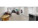 Carpeted bonus room setup with furniture and overlooking the bedroom and bathroom areas at 11623 Tetrafin Dr, Riverview, FL 33579