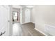 Bright foyer boasts wood floors, a window with red accents, and a white front door at 11623 Tetrafin Dr, Riverview, FL 33579