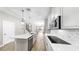 Bright open kitchen with white cabinets, quartz countertops and stainless appliances at 11623 Tetrafin Dr, Riverview, FL 33579
