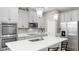 Modern kitchen features stainless steel appliances, gray cabinets, an island, and pendant lighting at 11623 Tetrafin Dr, Riverview, FL 33579
