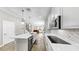Bright open kitchen with white cabinets, quartz countertops and stainless appliances at 11623 Tetrafin Dr, Riverview, FL 33579