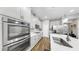 Updated kitchen with stainless appliances, shaker cabinets, island, and stylish pendant lighting at 11623 Tetrafin Dr, Riverview, FL 33579