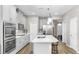 Bright kitchen with stainless steel appliances, white cabinets, an island with seating, and a modern backsplash at 11623 Tetrafin Dr, Riverview, FL 33579