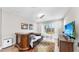 Cozy living room with hardwood floors, ceiling fan, tv and glass sliding doors at 11623 Tetrafin Dr, Riverview, FL 33579