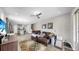 Open concept living room features hardwood floors, a ceiling fan, and views of the kitchen and staircase at 11623 Tetrafin Dr, Riverview, FL 33579