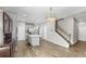 Open-concept living area with kitchen, island, and stairs showcasing modern design at 11623 Tetrafin Dr, Riverview, FL 33579