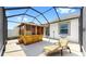Enclosed patio featuring an outdoor wooden cabana and a lounge chair at 11623 Tetrafin Dr, Riverview, FL 33579