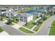 Aerial view of a two-story home with a nearby pond, landscaping, and a three car garage at 11726 Sunburst Marble Rd, Riverview, FL 33579