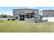 Large backyard featuring a patio with an outdoor kitchen, seating, and screened-in lanai at 11726 Sunburst Marble Rd, Riverview, FL 33579