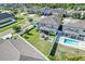 Aerial view of a home with a screened-in porch, outdoor seating, and a refreshing private pool at 11726 Sunburst Marble Rd, Riverview, FL 33579