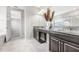 Bathroom featuring a double vanity, granite countertop, modern fixtures, and tile flooring at 11726 Sunburst Marble Rd, Riverview, FL 33579