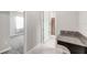Bathroom featuring granite vanity top, white door, and tiled floor at 11726 Sunburst Marble Rd, Riverview, FL 33579