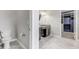 Bathroom with toilet, vanity with dark cabinets, and closet featuring customizable shelving at 11726 Sunburst Marble Rd, Riverview, FL 33579