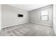 This bedroom features plush carpet, a ceiling fan, and a wall-mounted TV at 11726 Sunburst Marble Rd, Riverview, FL 33579