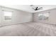 Large bedroom with plush carpet, ceiling fan, and natural light from windows at 11726 Sunburst Marble Rd, Riverview, FL 33579