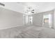 Spacious bedroom featuring plush carpet, a ceiling fan, and two windows allowing natural light at 11726 Sunburst Marble Rd, Riverview, FL 33579