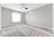 Cozy bedroom featuring plush carpet, ceiling fan, and a window with curtains at 11726 Sunburst Marble Rd, Riverview, FL 33579